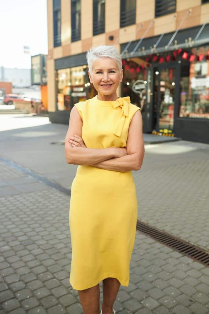 femme âgée en robe droite jaune